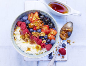 Porridge Bowl mit Ahornsirup, Früchten und Nüssen